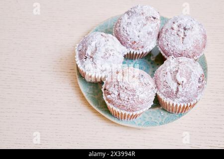 Closeup five cupcakes on plate on table. Stock Photo