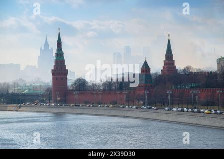 Kremlin embankment, cars on road, city in fog in Moscow, Russia Stock Photo