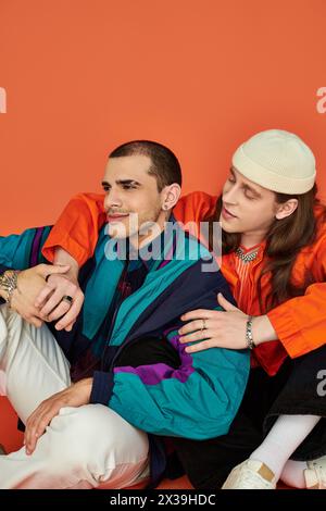 Two men sit closely together, showing affection. Stock Photo