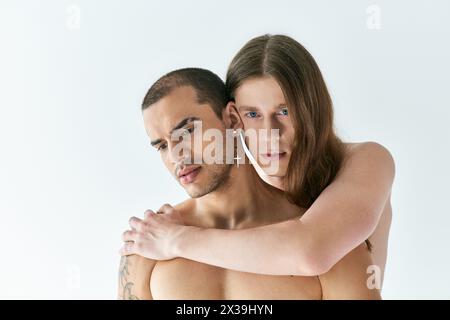 Two men share a heartfelt hug with smiles on their faces. Stock Photo