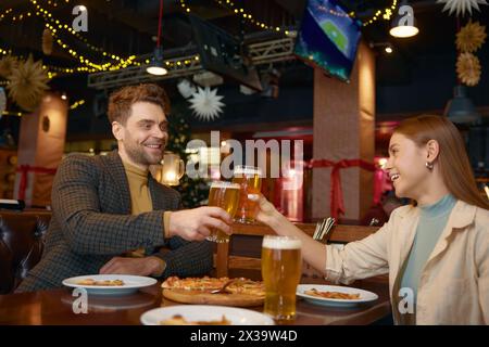 Friends drinking beer while rest in pub Stock Photo
