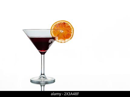 Dark purple drink in cocktail glass with slice of blood orange isolated on white background Stock Photo