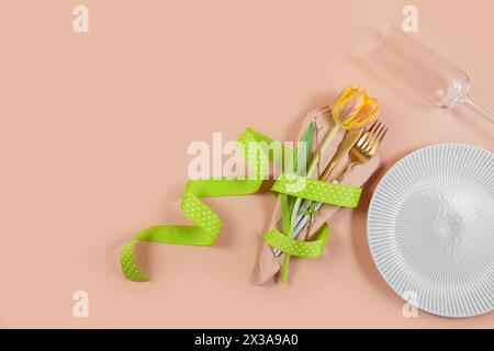 Spring-Themed Table with Tulips and Cutlery Stock Photo