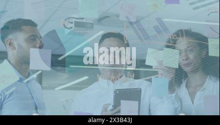 Image of financial data processing over diverse businesspeople in office Stock Photo