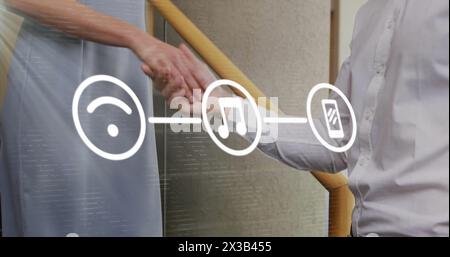 Image of flowchart of icons over caucasian woman walking downstairs and shaking hands with man Stock Photo