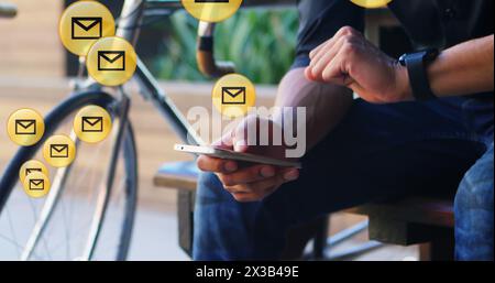 Image of envelope icons floating against mid section of man using smartphone in the background Stock Photo