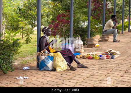 An adult African young from the Maasai tribe sells jewelry in her shop on the street. Amboseli National Park, Kenya. February 6, 2024. Stock Photo