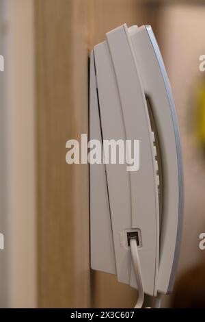 Wall-mounted telephone for calling service personnel. Close-up. Stock Photo