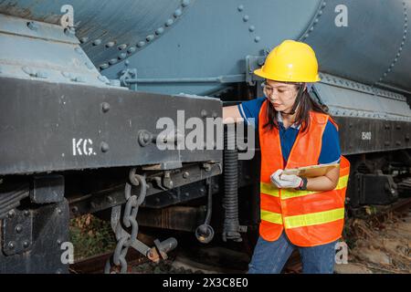 engineer women worker servicing check train. young teen maintenance locomotive rail transport vehicle. Stock Photo