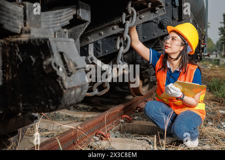 engineer women worker servicing check train. young teen maintenance locomotive rail transport vehicle. Stock Photo