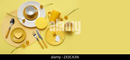 Beautiful table setting with dandelions flowers on yellow background with space for text Stock Photo