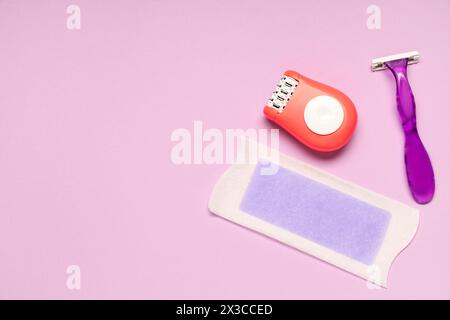 Modern epilator with razor and wax strip on lilac background Stock Photo