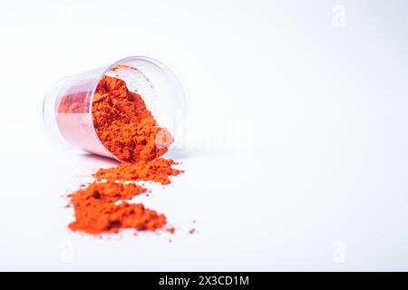 Colourful holi powder in plastic containers isolated on white background with copy space Stock Photo