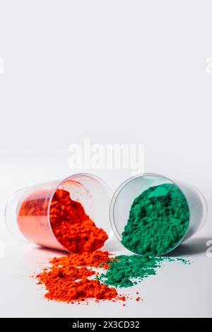 Colourful holi powder in plastic containers isolated on white background with copy space Stock Photo