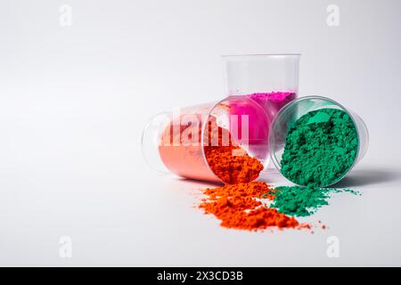 Colorful holi powder in glass bowl isolated on white background with copy space. Selective focus. Stock Photo