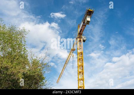 Construction crane working on large construction site Stock Photo