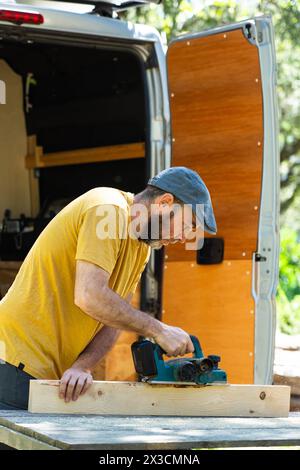 Man working to camperize his camper van Stock Photo