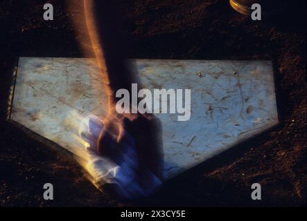 Umpire cleaning home plate Stock Photo