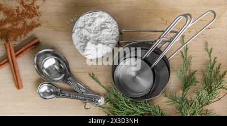Stainless measuring tools and ingredients with festive greenery Stock Photo