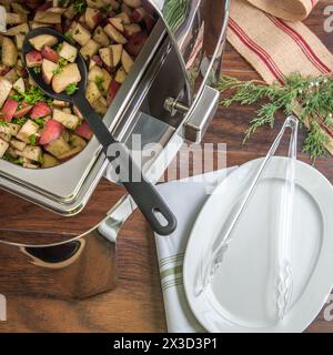 Elegant buffet setup with a stainless steel chafing dish Stock Photo