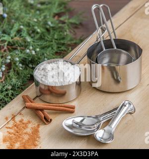 Stainless steel measuring tools and ingredients on festive backdrop Stock Photo