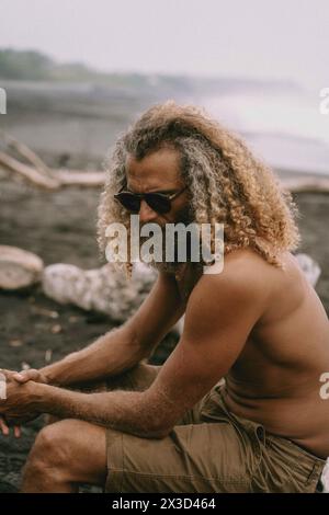 Stylish man with long curly blond hair Stock Photo