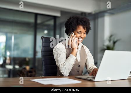 Making A Work Call Happy professional woman executive making call talking on phone at work ...