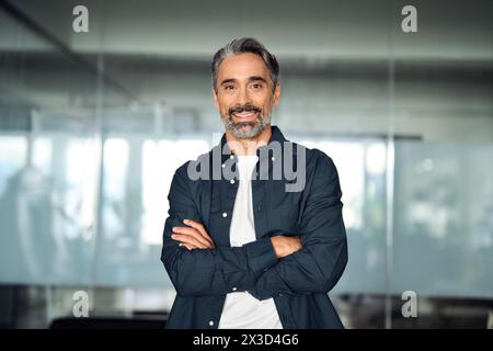 Smiling middle aged business man investor looking at camera in office, portrait. Stock Photo
