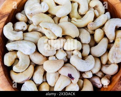 cashew nut (Anacardium occidentale), Cashew nuts in a wooden bowl on a wooden table Stock Photo