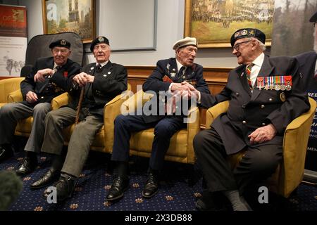 D-Day veterans Alec Penstone (second right), 98, who served with the Royal Navy, shakes hands with Ken Hay (right), 98, Ambassador for the British Normandy Memorial who served with the 4th Dorset Regiment, at the D-Day 80 launch event organised by the Spirit of Normandy Trust, in conjunction with the British Normandy Memorial, at the Union Jack Club in London. The event is one of the largest UK gatherings of D-Day and Normandy veterans for many years, and brings together some of the last remaining members of what is known as The Greatest Generation. Picture date: Friday April 26, 2024. Stock Photo