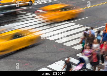 Pedestrians & yellow taxi cabs on pedestrian crossing, Central Manhattan, New York, U.S.A. Stock Photo