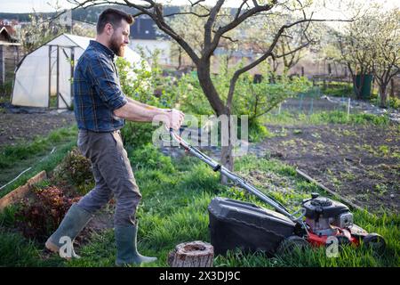 moving the lawn in green garden Stock Photo