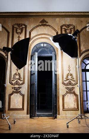 Two light source in front of the open glass doors in an ancient palace interior Stock Photo