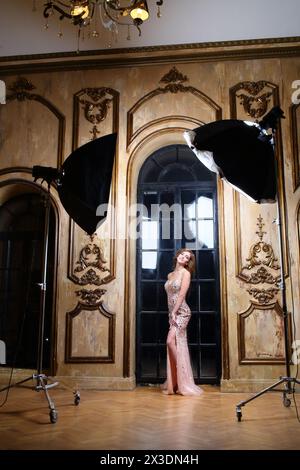 Actress in pink evening dress with sequins hugged herself near the ...