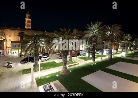 SPLIT, CROATIA - MAY 21, 2017: Alley decorated with palm trees and flower beds in the Croatian city of Split at the evening Stock Photo