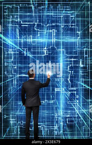 businessman touching a screen with a glowing tech schematic Stock Photo