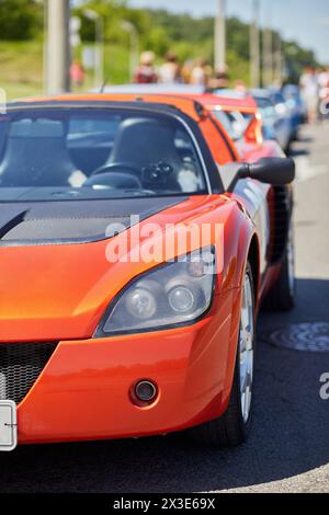 MOSCOW, RUSSIA - MAY 27, 2018: Several sports cars stand on curb of highway.. Stock Photo