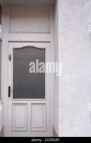 simple old style white door with glass cover Stock Photo