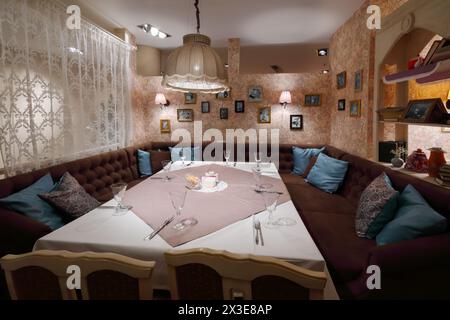 Serving on table with tablecloth in home-style restaurant with couch Stock Photo