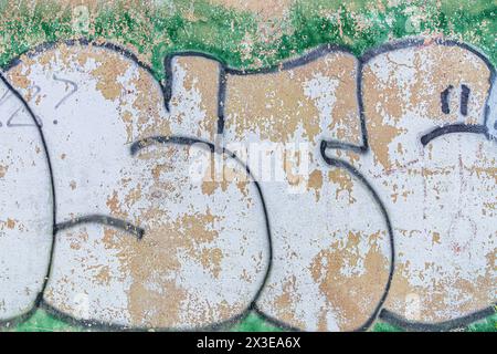 Abstract detailed wall texture with green white graffiti paint. Stock Photo