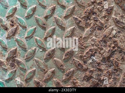 Surface On An Old Sheet Of Metal Texture, Cross-embossed to make it less slippery for walking. Metal sheet plate with a rough brown-orange rust, Abstr Stock Photo