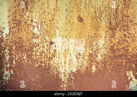 Paint peeling crackling off brown rusty metal texture background. Green paint peeling off rusty metal background. Design element. Stock Photo