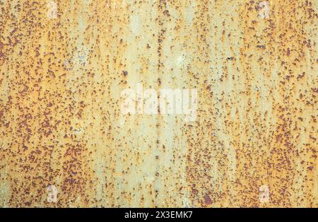 Paint peeling crackling off brown rusty metal texture background. Green paint peeling off rusty metal background. Design element. Stock Photo