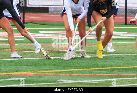 Three high school girls fighting for the ball during a game. Stock Photo