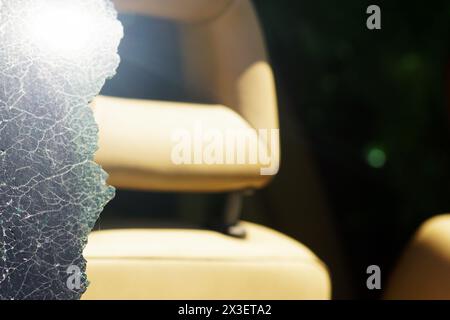 A car after an accident: a piece of broken rear window and a seat back in the background Stock Photo