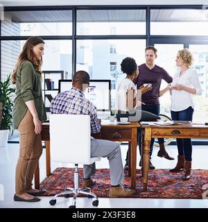 Creative people, discussion and meeting with team for collaboration, ideas or creativity at office. Young group of employees working, talking or Stock Photo