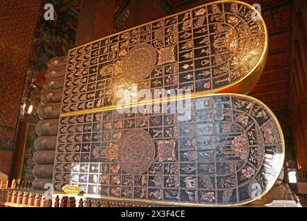 Soles of Reclining Buddha's Feet in Wat Pho Temple, Inlaid 108 Auspicious Symbols with Mother of Pearl, Bangkok, Thailand Stock Photo