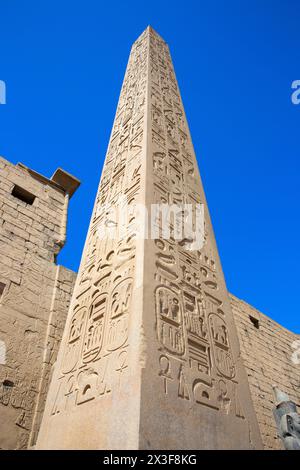 Close-up of the red granite obelisk of Ramesses the Great at the main entrance of Luxor Temple (a UNESCO World Heritage Site) in Luxor, Egypt Stock Photo