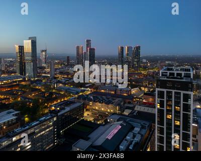 Dusk captures the city in a transitional phase, the sky still holding the last light as buildings begin to glow from within Stock Photo