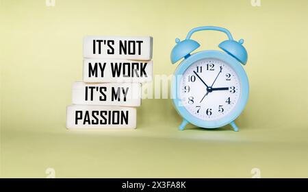 Business concept. Wooden blocks with the inscription This is not my work. This is my passion on a light background, next to the clock Stock Photo